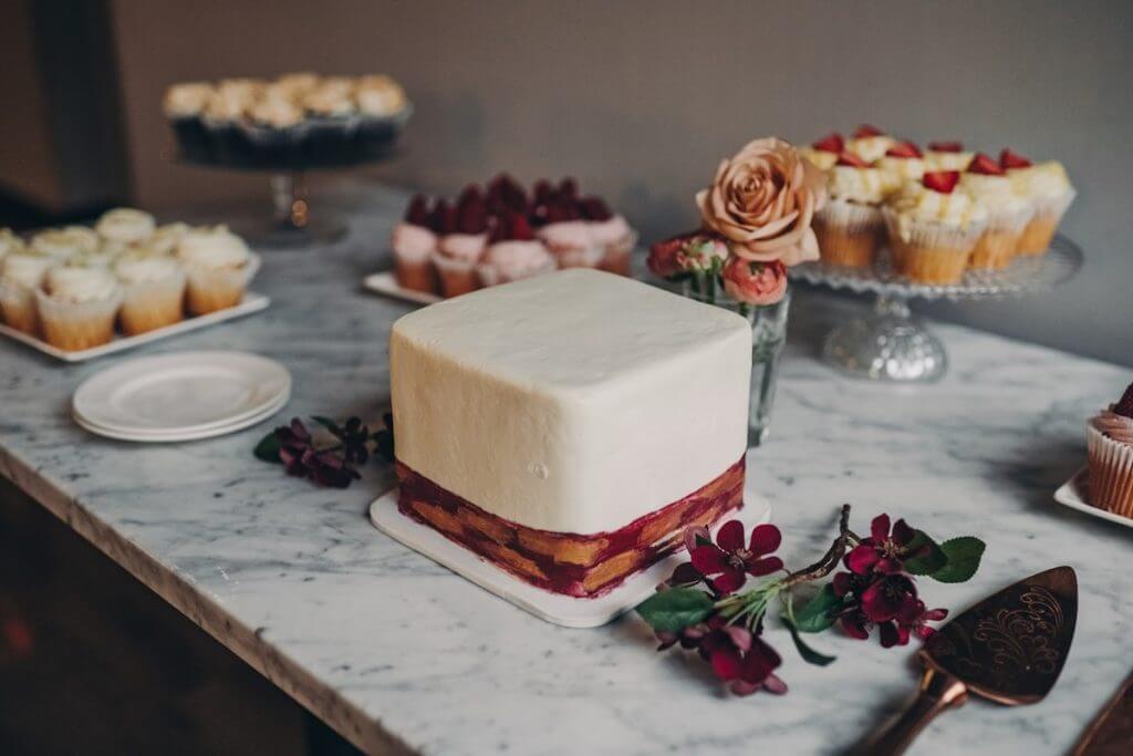 red velvet wedding cake with white frosting on a table at a wedding reception