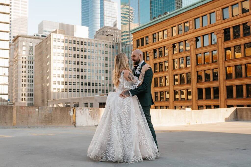 Minneapolis wedding photo with bride and grooing dacing rooftop