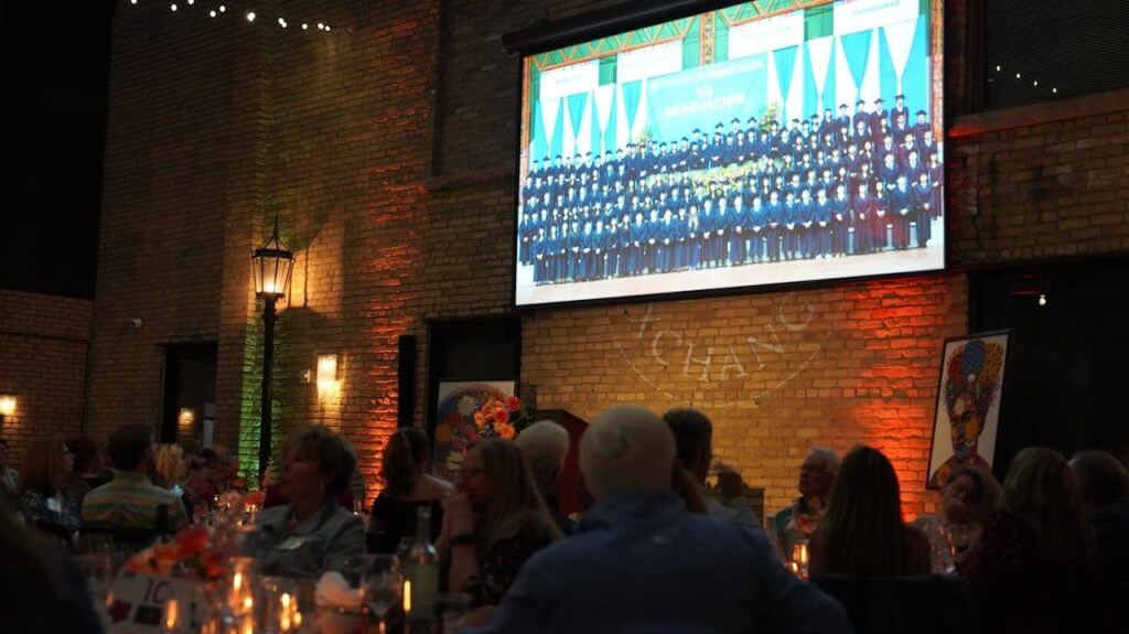 graduation party slideshow being viewed on large projector screen