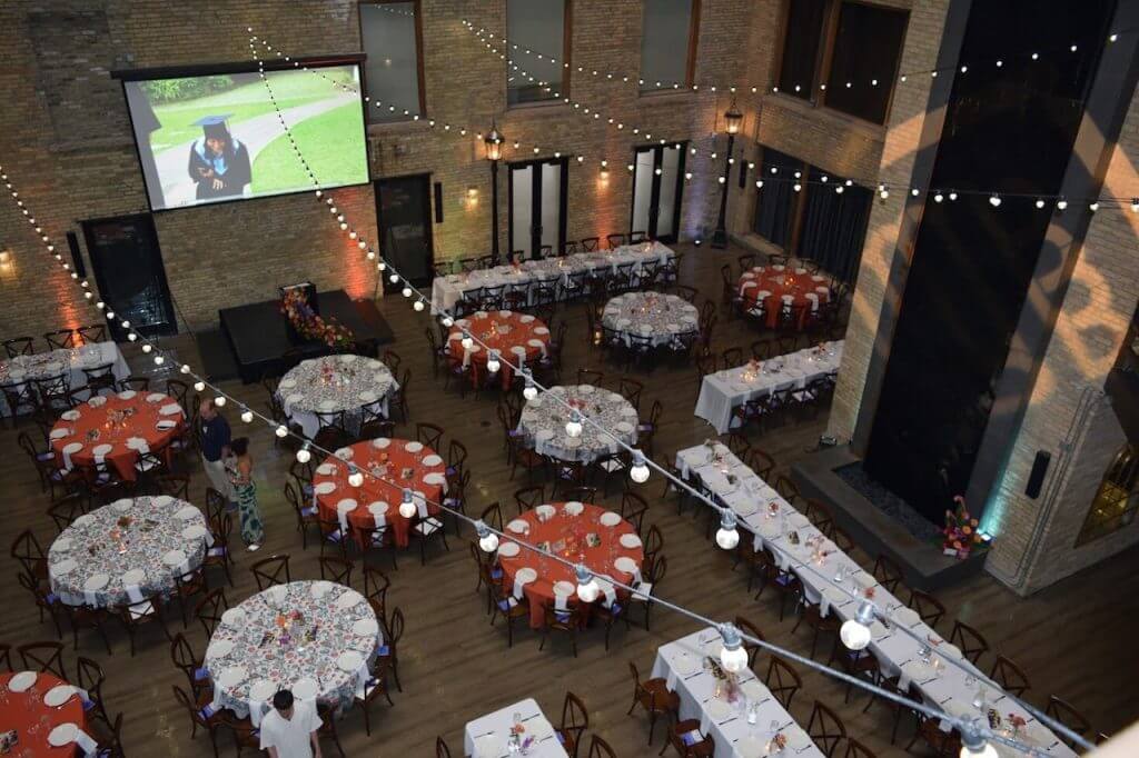 aerial view above the Lumber Exchange before a gradation party, showing tables setup with alumni colors